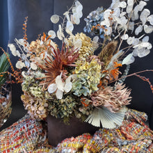 Load image into Gallery viewer, A dried floral arrangement featuring pale eucalyptus stems, muted hydrangea blooms, orange accents, and textured botanical elements - Blanc Flowers