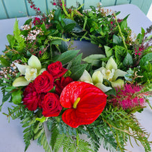 Load image into Gallery viewer, Large ANZAC wreath by Blanc Flowers in red and green features NZ and Australian native plants with an arc of flowers