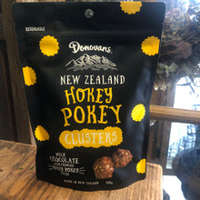 Load image into Gallery viewer, At Blanc Flowers we all love Donovans NZ Hokey Pokey Clusters, 150 g packet black packaging with yellow writing. 
