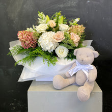 Load image into Gallery viewer, Beautiful gift set for mum and newborn to enjoy. Large sized boxed posy of pastel tone blooms with green foliage, includes a cute neutral colour knitted teddy bear.
