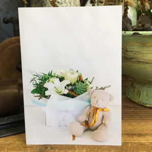 blanc card featuring blanc baby flowers (posy box) and neutral colour teddy  