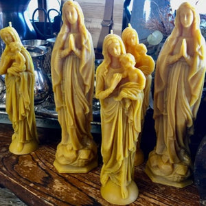 Blancs Madonna Beeswax candles in in natural wax colour and in two sizes. Small is Madonna holding baby Jesus and Large is Madonna in Prayer stance  with Rosary Beads.