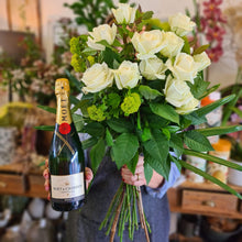 Load image into Gallery viewer, Blanc Flowers offers a range of flowers and wine for local delivery, image showes a dozen white roses in a bouquet and a 750ml bottle of French Moet &amp; Chandon Imperial Brut Champagne.
